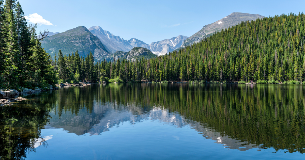 Colorado mountains behind a calm lake on a clear day